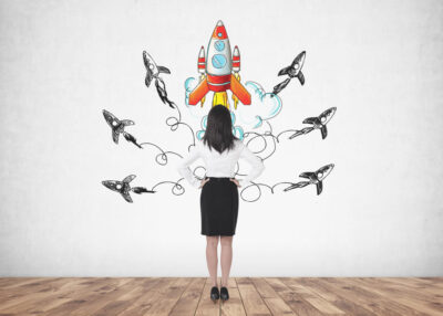 woman looking to hand drawn rocket launches represeneting the increased speed and volume with quoting automation using SAP CPQ