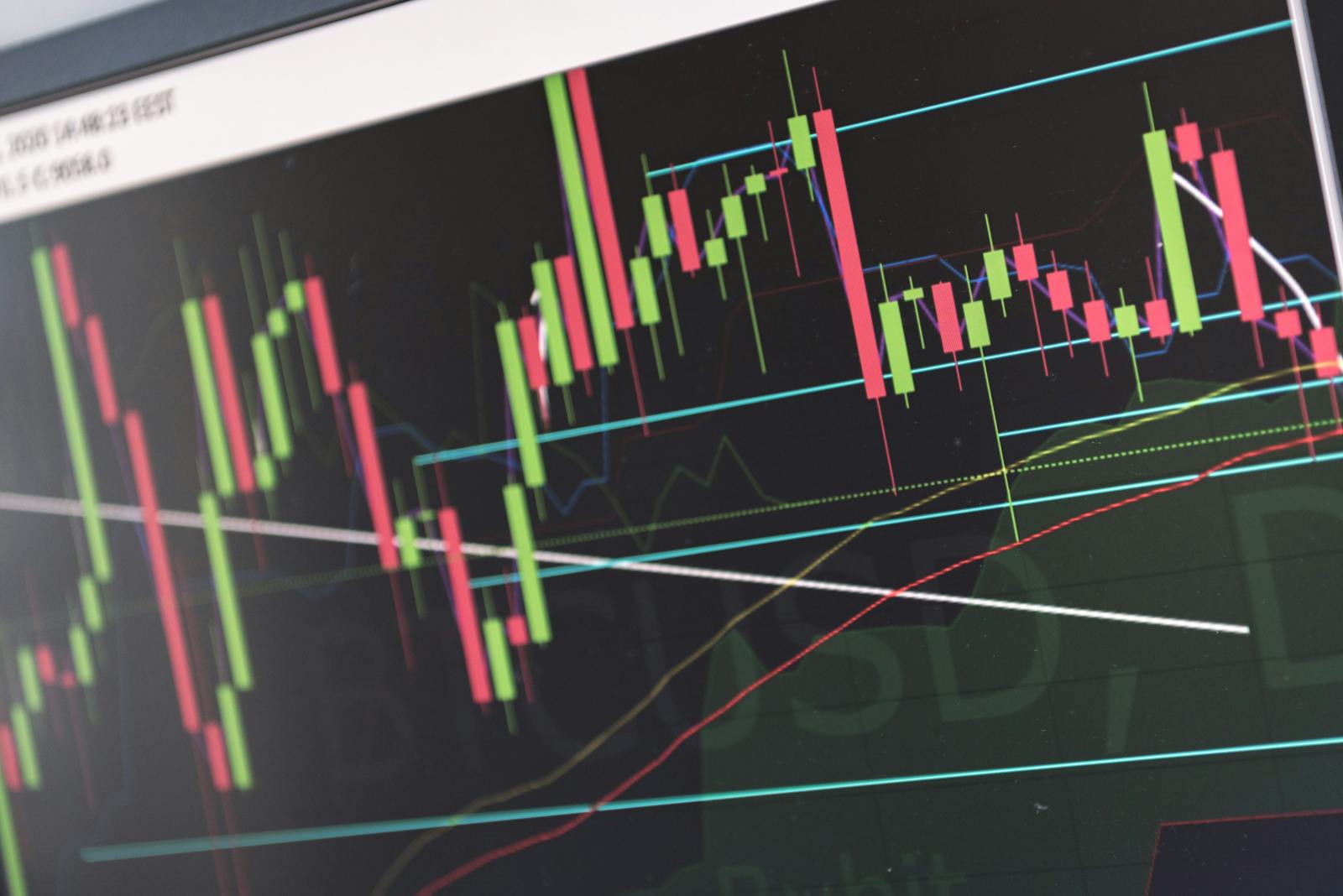 Close-up of vibrant stock market graphs displaying trading trends on a monitor, ideal for finance and cryptocurrency concepts.
