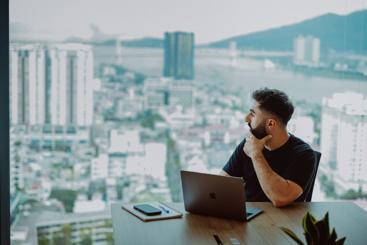 Man looking out window at city skyline