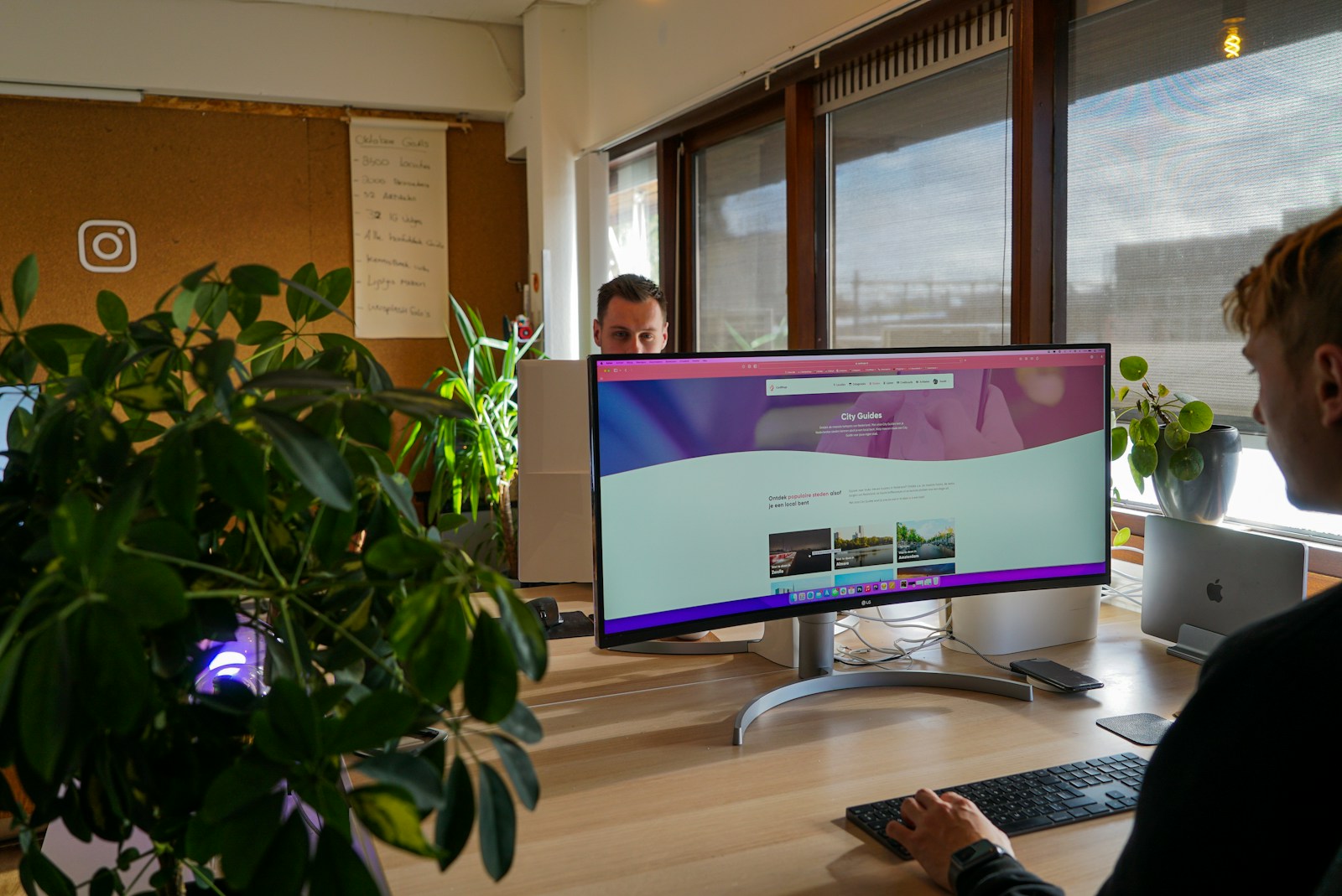 Modern workspace with curved monitor, keyboard, and plants illustrating SAP CPQ in a digital business environment.
