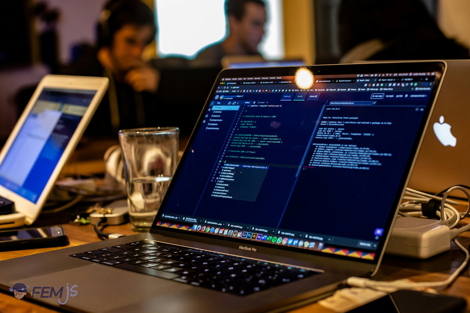 SAP CPQ product configuration training with developer working on coding interface on laptop.