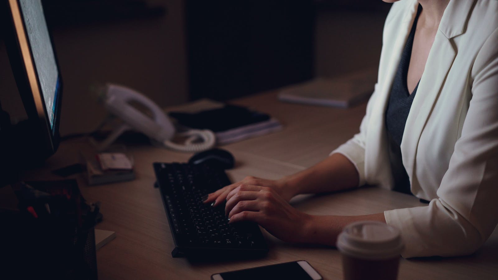 Professional working at a computer in an office environment, representing SAP CPQ Training for Product Managers focused on product configuration and quote management.