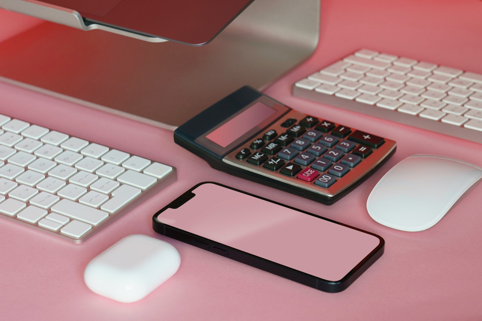 Modern workspace with smartphone, calculator, and computer accessories, representing SAP CPQ and S/4HANA Pricing integration for accurate pricing and business operations.