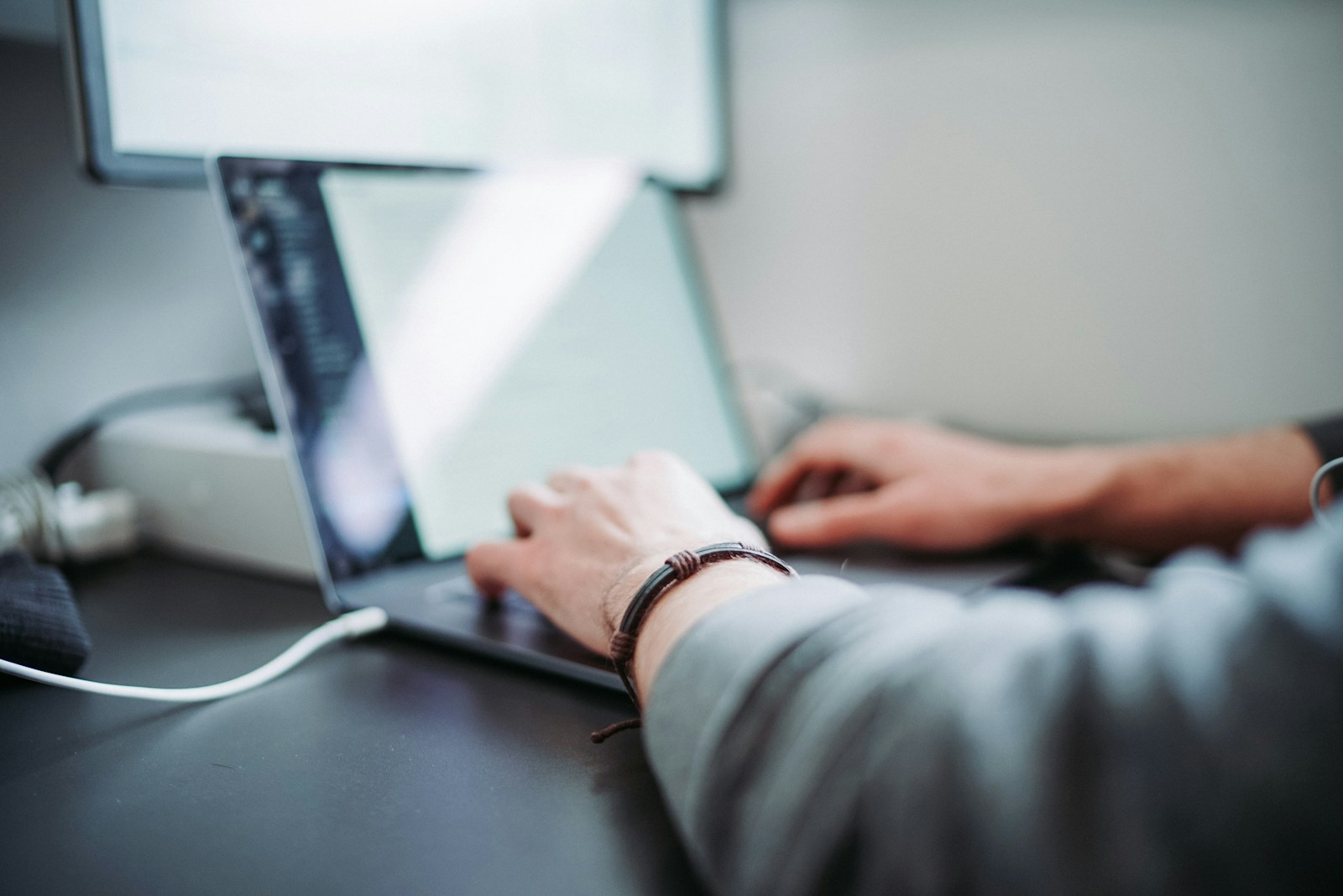 Professional working on a laptop in a modern office environment, representing experienced SAP CPQ Admins managing configuration, pricing, and quote optimization.
