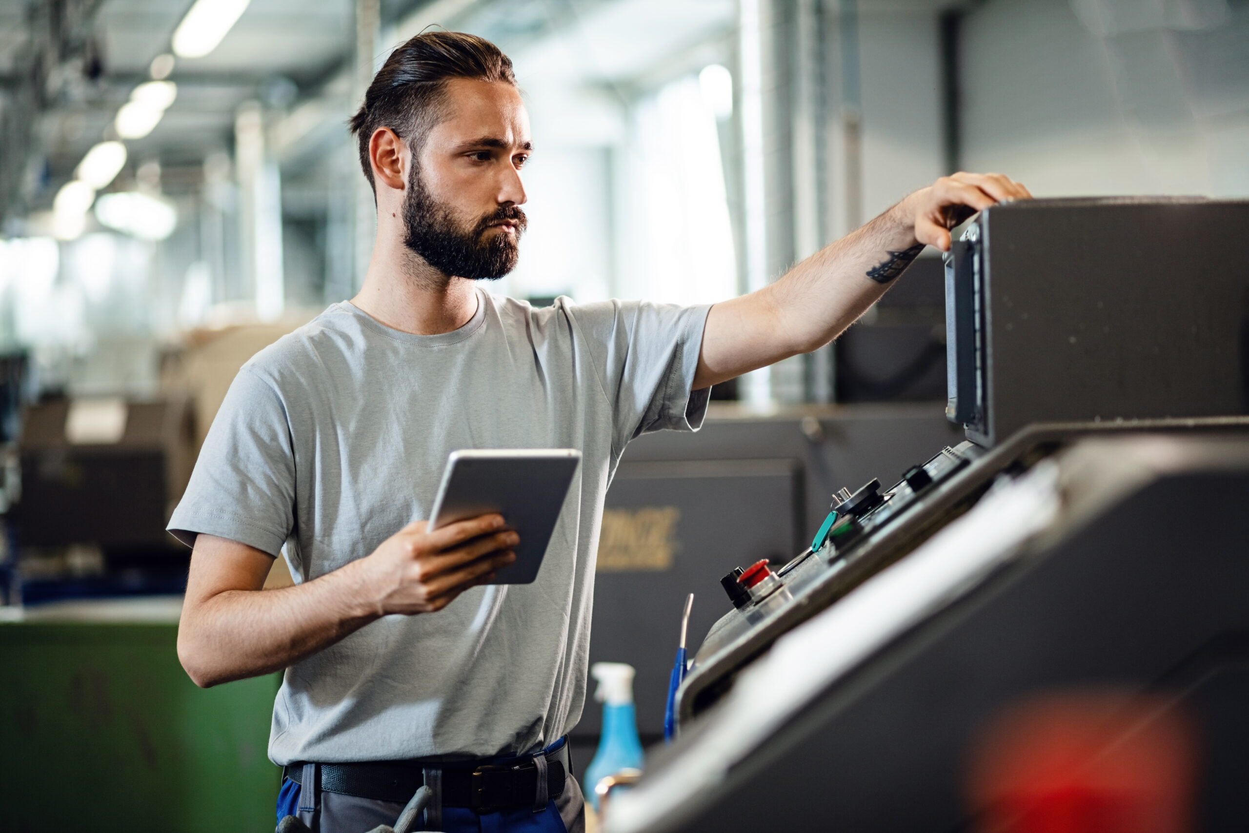 Engineer configuring a machine on a factory floor, an example of the product complexity that drives SAP CPQ quote configuration