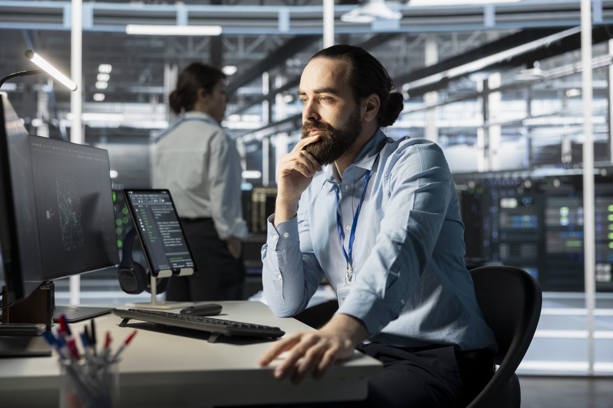 System administrator working at a workstation inside a data center