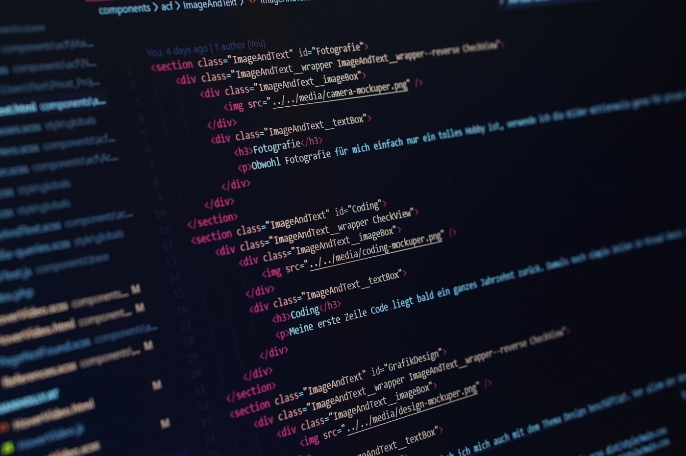Markup code with angle bracket tags and nested sections shown on a dark computer screen